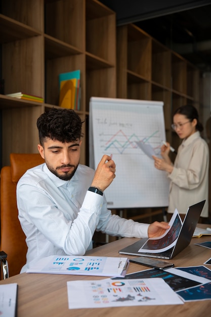 Office workers using finance graphs