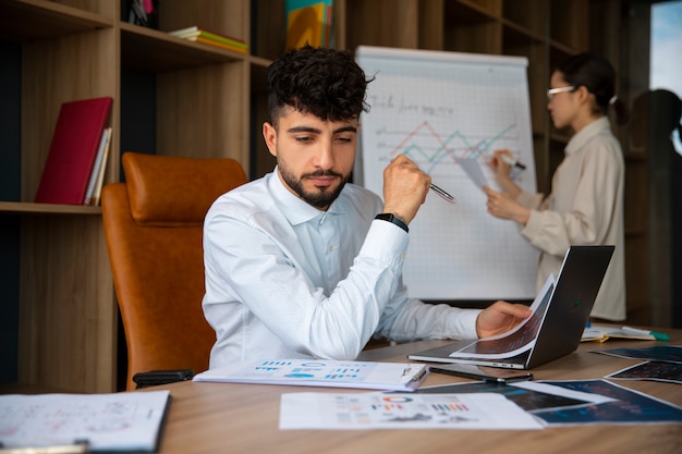 Office workers using finance graphs