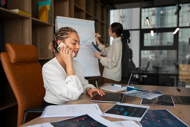 Office workers using finance graphs