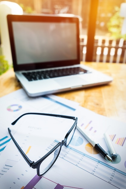 Free Photo office workplace with laptop and glasses on wood table