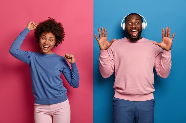 Oh yes its our song! Joyful millennial curly woman and man dance and have fun, unbothered about opinion, celebrate passed exam, make disco move