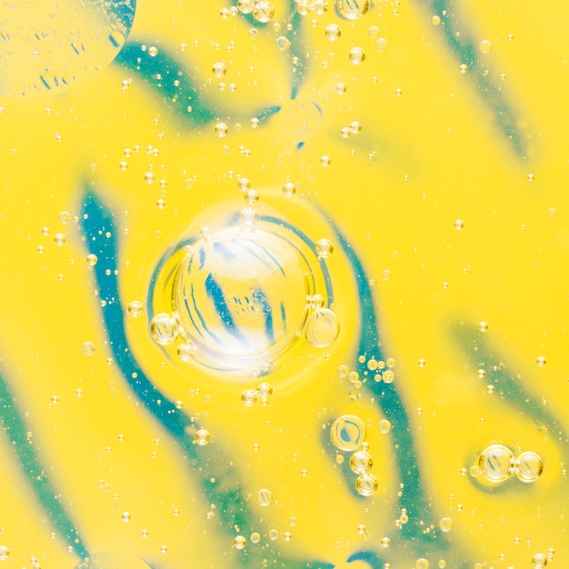 Free Photo oil bubbles floating on beautiful pattern yellow background