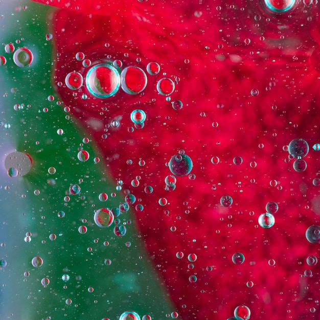 Free Photo oil bubbles floating on green and red water surface