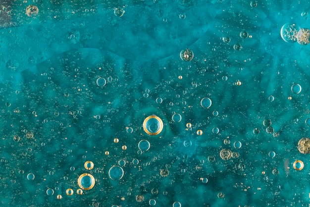 Free photo oil bubbles over green water surface