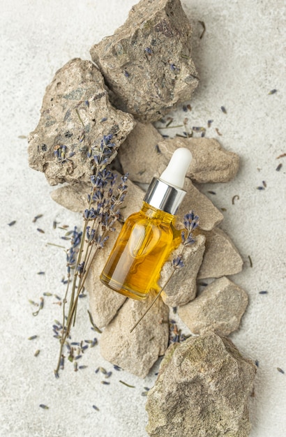 Free Photo oil dropper and lavender on rocks