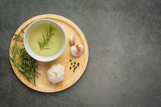 Oil with rosemary on table