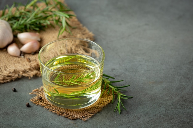 Oil with rosemary on table