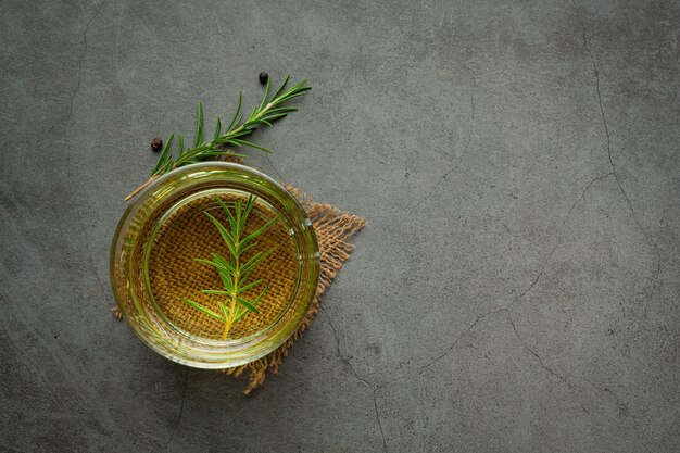 Oil with rosemary on table