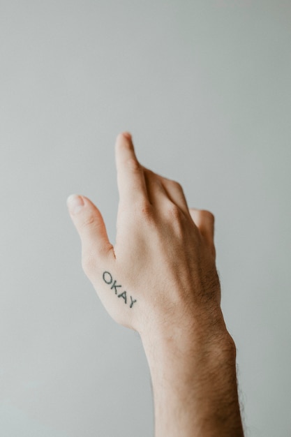 Free Photo okay word tattooed on a hand