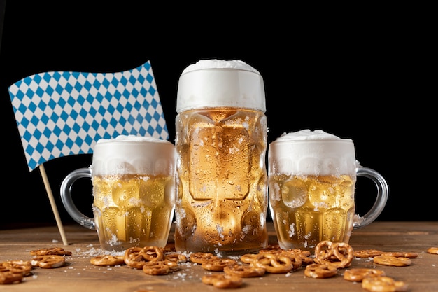 Free photo oktoberfest beer mugs with snacks on a table