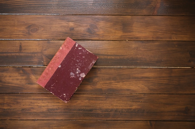 Free photo old book on wooden background