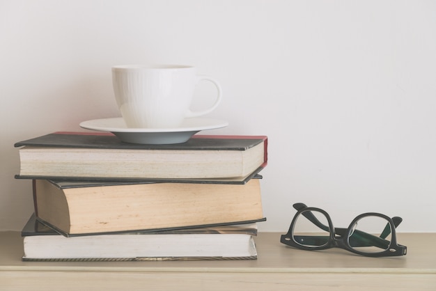 Free Photo old books with cup and glasses