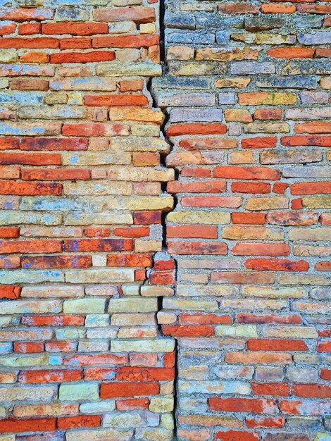 Old brick wall split by a crack