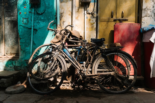 Free photo old broken bicycles left outside of the house