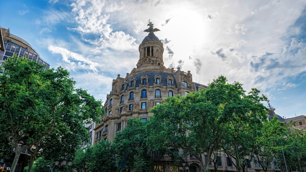 An old building made in classic style, greenery in Barcelona, Spain