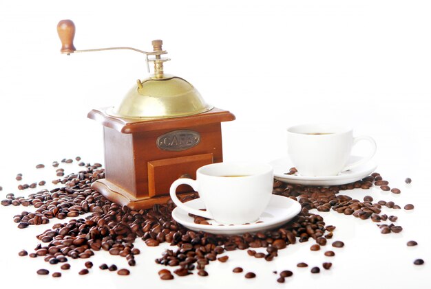 Old coffee grinder with white cup