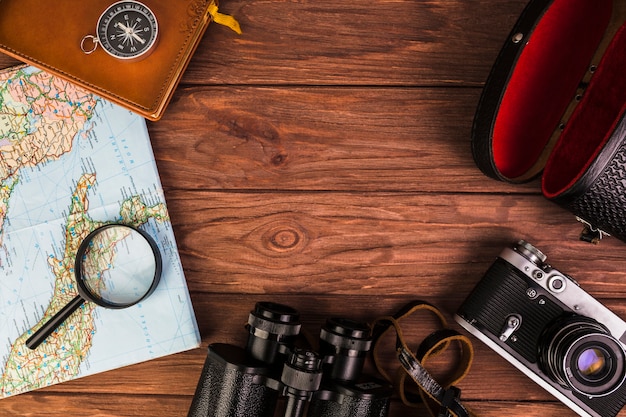 Free photo old fashionable travel stuff on wooden table