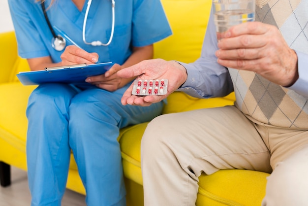 Old man holding his pills