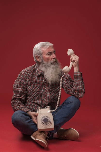 Old man holding a telephone