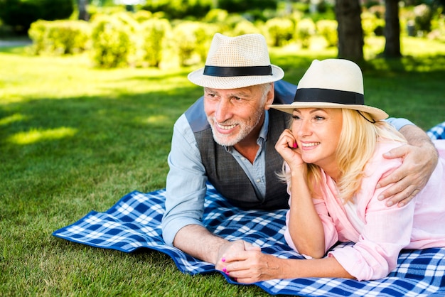 Old man hugging his woman on a blanket