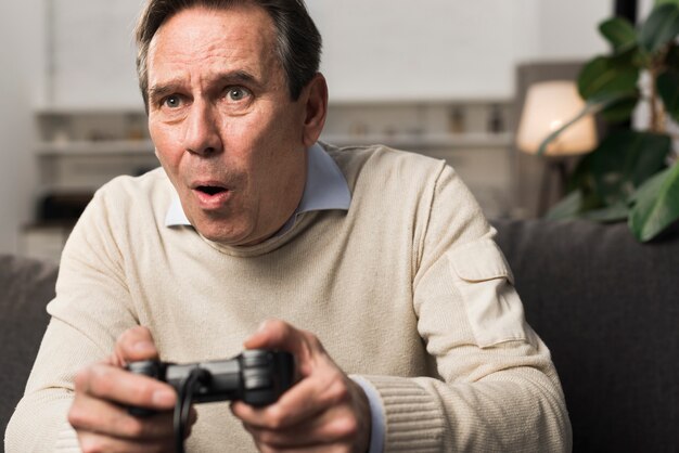 Old man playing videogame