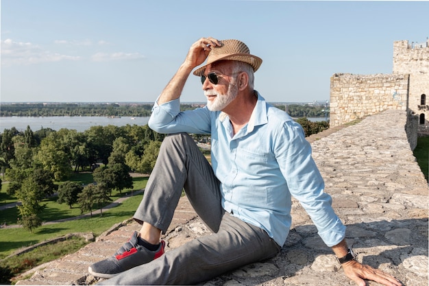 Old man sitting down while looking away