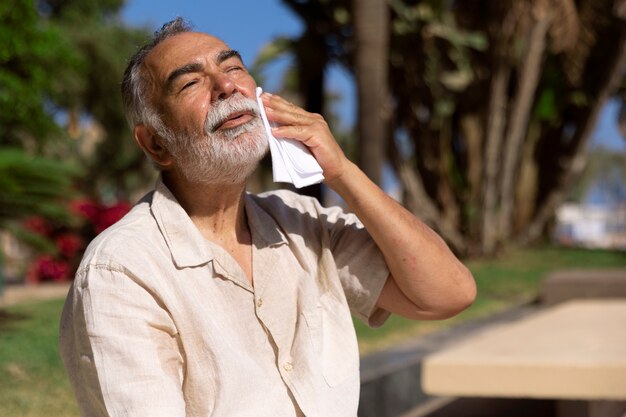 Old man struggling with high temperature