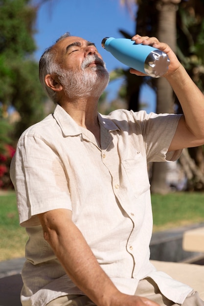 Old man struggling with high temperature