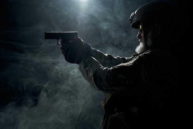 Old military officer pointing with gun