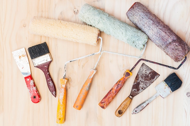 Free photo old painting brush set, hand tool, over white wooden background