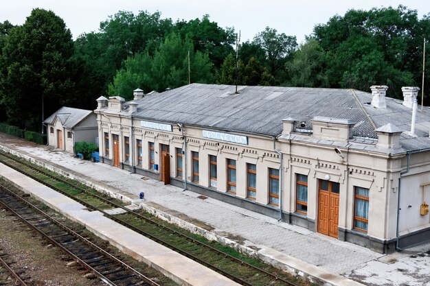 Old railroad station with railways in front of it