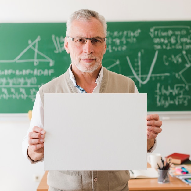 Free photo old teacher showing clear sheet of paper