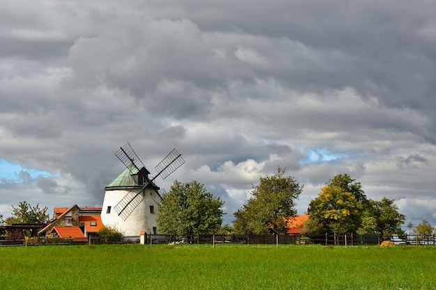 Free Photo old windmill - czech republic europe. beautiful old traditional mill house with a garden