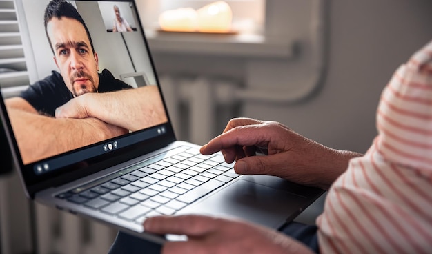 Free photo an old woman communicates with her son via video link through a laptop