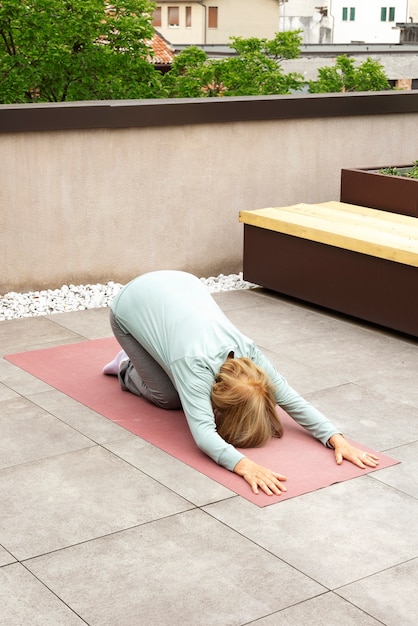 Old woman doing fitness exercises