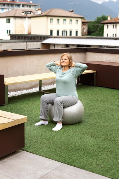 Old woman doing fitness exercises