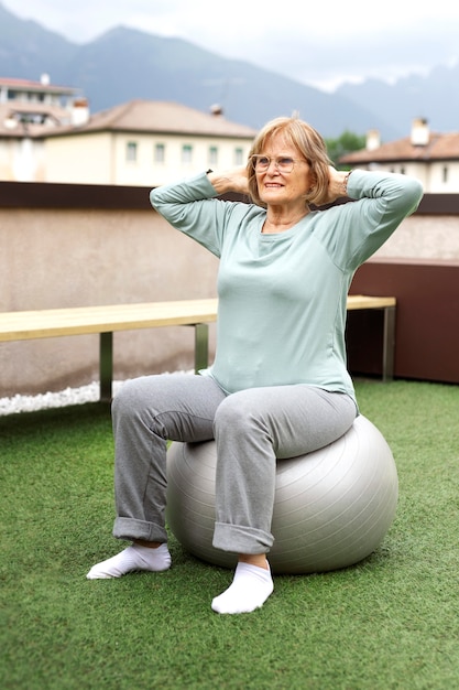 Old woman doing fitness exercises