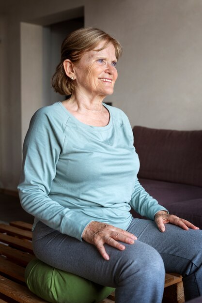 Old woman doing fitness exercises