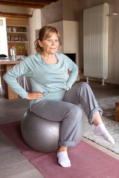 Old woman doing fitness exercises