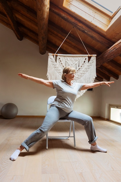 Free photo old woman doing fitness exercises