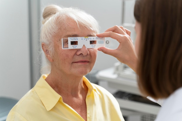 Old woman having an eye sight check at an ophthalmology clinic