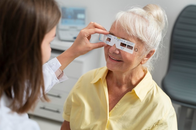 Free Photo old woman having an eye sight check at an ophthalmology clinic