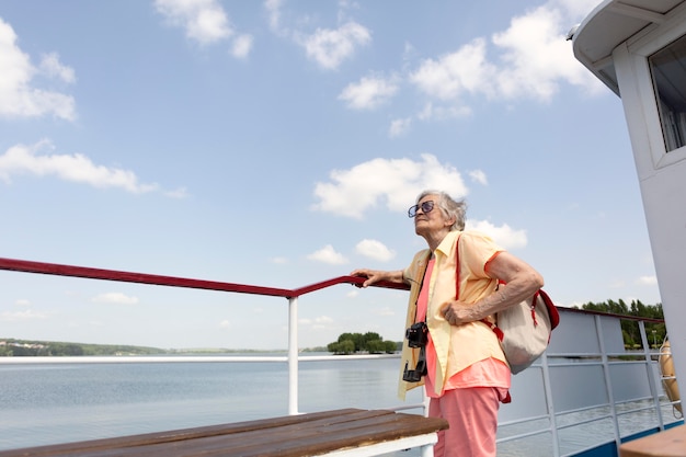 Free Photo old woman traveling alone in the summertime