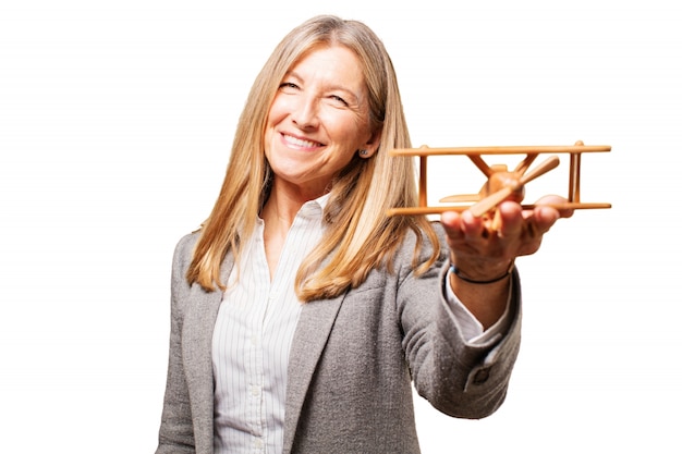 Free photo old woman with a wooden plane