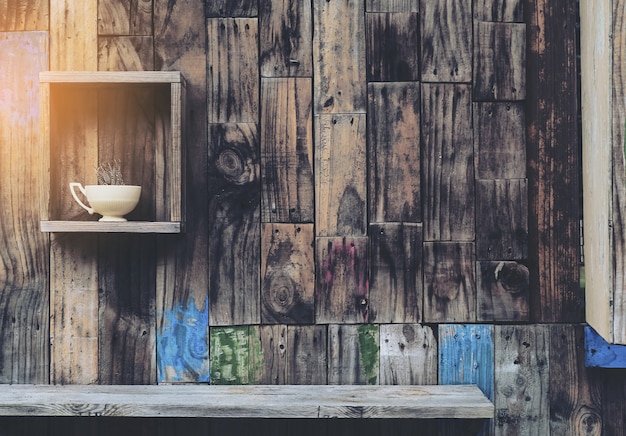 Free photo old wooden wall background with shelves and old coffee cup