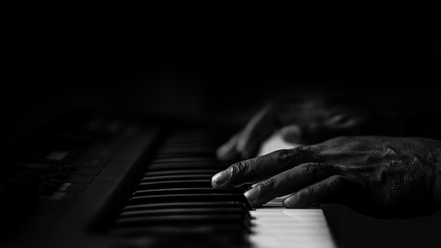 Free photo old wrinkled hands on a piano