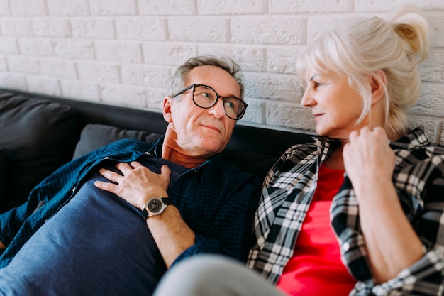 Older couple on couch in retirement home