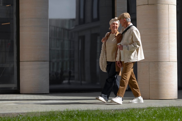 Free Photo older couple outdoors in the city with a cup of coffee