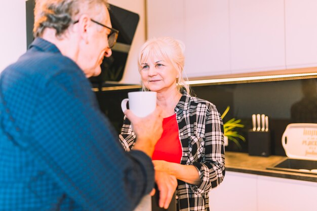 Older couple in retirement home drinking coffee