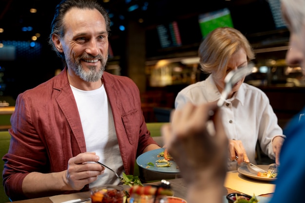 Older friends eating at a restaurant